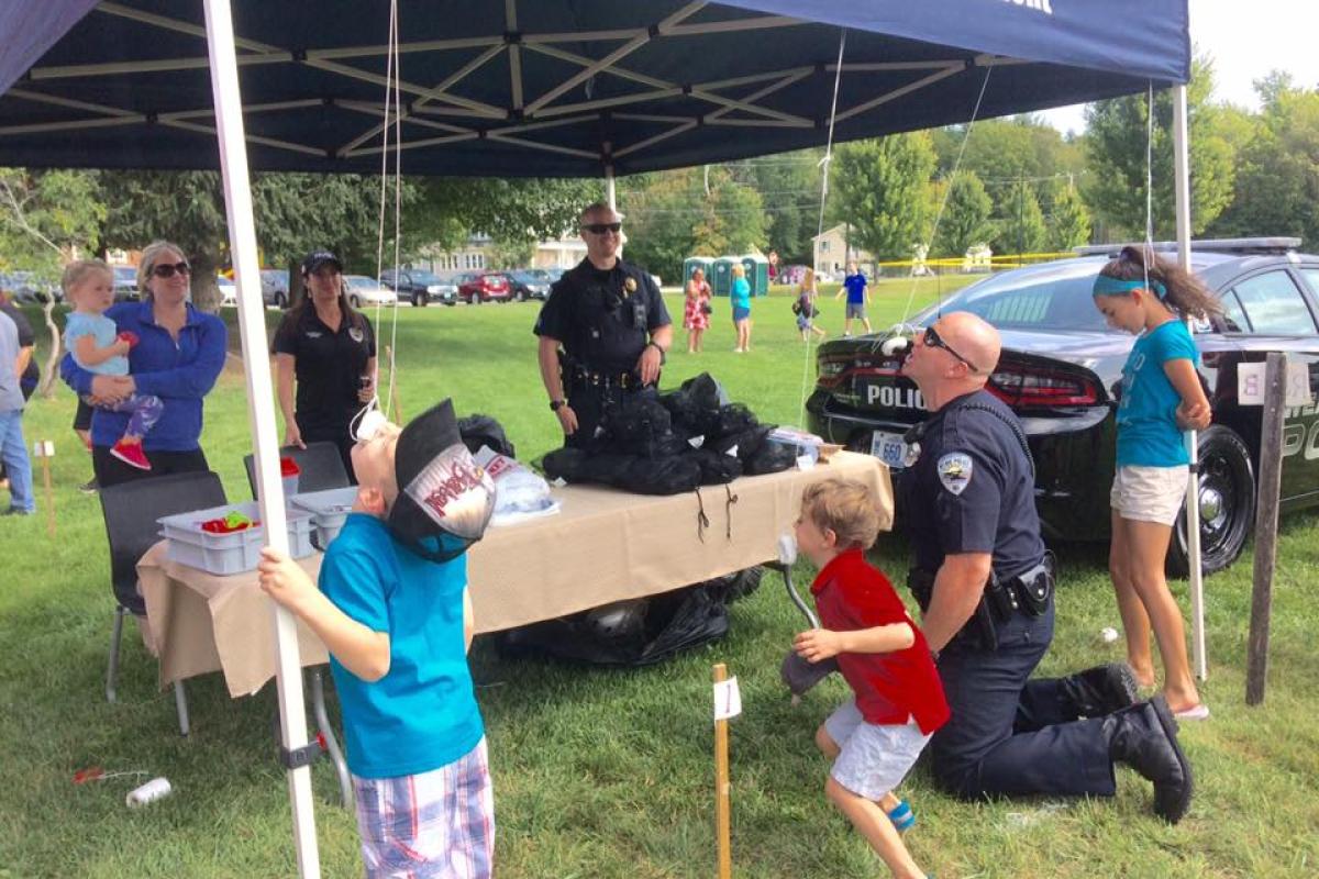 Old Home Day 2017: Officer Muise Challenging some young residents to a donut eating contest