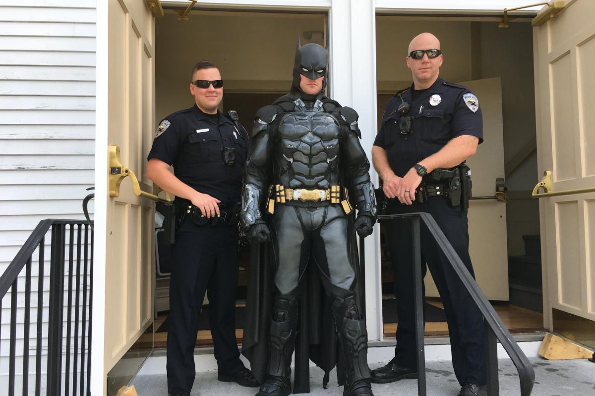Police with man dressed as Batman