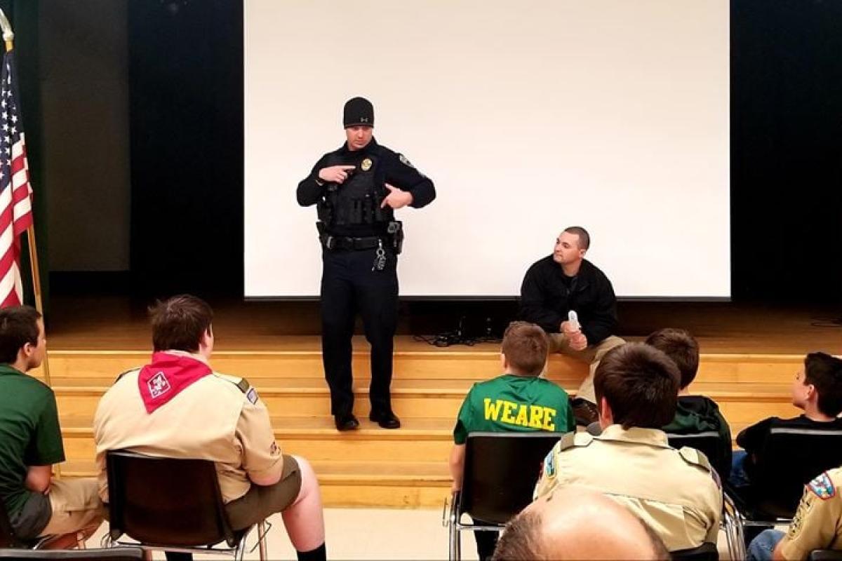 Officers speaking to Boy Scouts