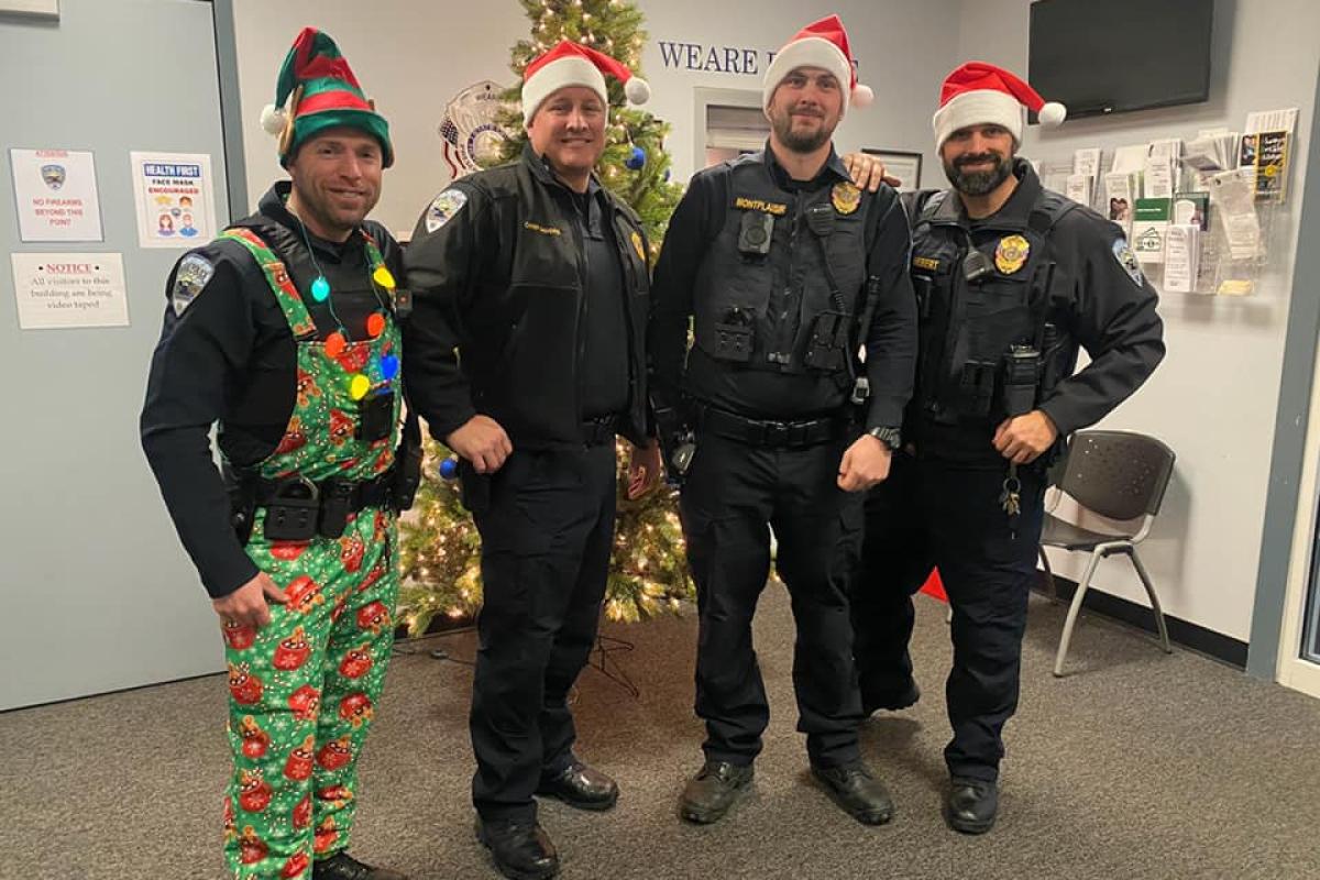 Chief Moore, Lieutenant Hebert, Sergeant Montplaisir and Officer Chris George prepare to hand out presents to children within the community (December 2021)